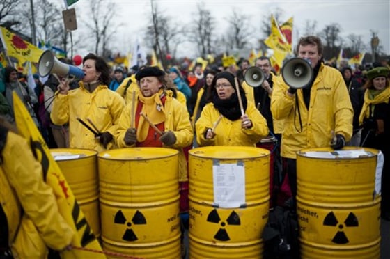 Demonstrators drum on barrels with a nuclear sign, during protests against a nuclear waste transport in Dannenberg, northern Germany, on Nov. 26. The shipment of nuclear waste reprocessed in France is on its way to a controversial storage site in Gorleben that protesters say is unsafe. It is the first such shipment from France to Germany since Berlin decided to shut all its nuclear plants by 2022, following the disaster at Japan's Fukushima plant. The transport is due to arrive at the storage site on Sunday.